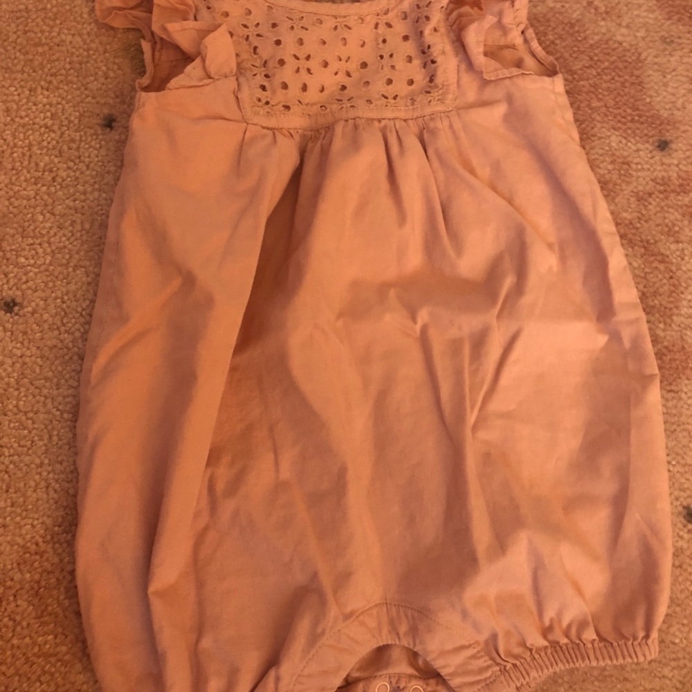 A light rose colored baby Gap Romper.
